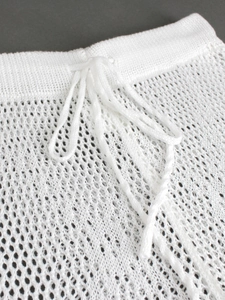 White knitted beach pants with drawstring waist and intricate hollow crochet pattern