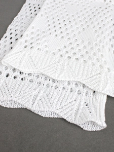 White pointelle knit crop top with delicate scalloped edges and hollow mesh texture