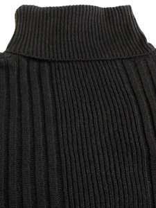 Women's black ribbed turtleneck knit sweater with long sleeves in a close-up texture view