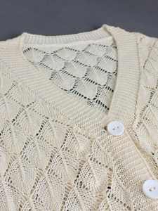 Creamy white V-neck hollow knit short cardigan with delicate leaf pattern textures