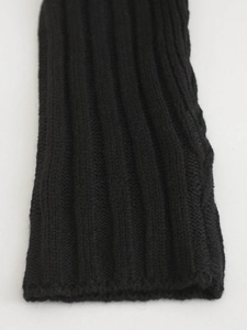 Close-up of black ribbed knit long sleeve cuff showing detailed texture and elasticity