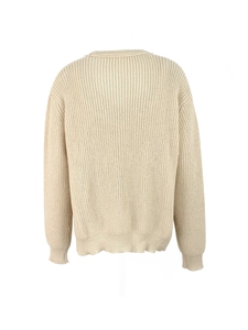 Détail d'un pull en maille côtelée beige avec d'élégantes perles brodées sur l'encolure