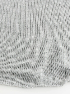 Detailed close-up of light gray knit fabric showing professional V-stitch texture