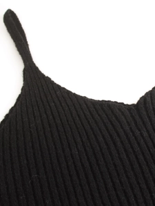 Close-up of black ribbed knit camisole showing vertical striped texture and stitching