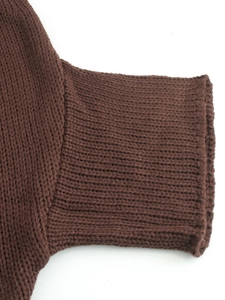 Close-up of ribbed knit cuffs on dark coffee brown batwing sleeve crewneck sweater