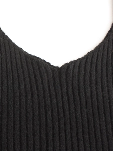 Close-up of ribbed knit V-neck camisole set in black featuring soft vertical texture