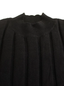 Detail of black mock neck knit top featuring premium vertical ribbed texture and finish