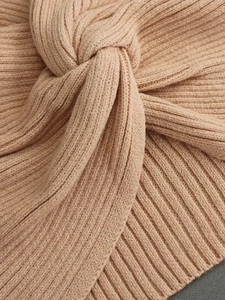 Detailed macro view of camel knit camisole featuring a twist knot design and ribbed texture