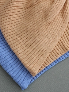 Close-up of camel and lilac rib-knit camisole set showing soft elastic texture
