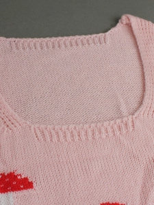 Pink knit two-piece top with square neck and red mushroom jacquard pattern detail