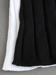 Macro view of ribbed knit cuffs on black and white long sleeve slim sets