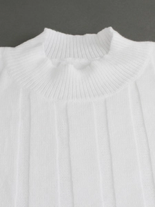 Detail of white ribbed knit sweater featuring a mock neck and vertical texture design
