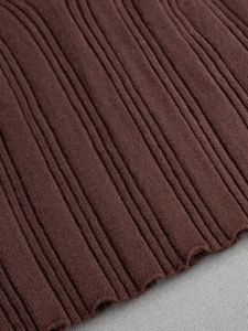 Macro shot of dark brown ribbed knit fabric with vertical stripes and elastic texture