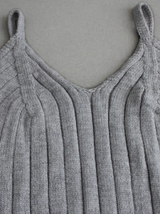 Macro detail of V-neck knitted grey tank top showing ribbed texture and stitching quality