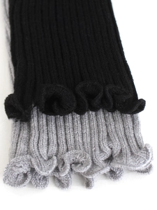 Two-piece ribbed knit leg warmers in black and grey with feminine ruffled lettuce edges