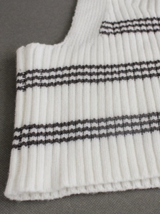 White ribbed knit two-piece set featuring black striped pattern and soft texture