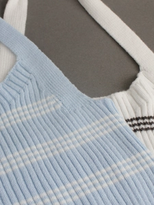 Close-up of minimalist striped knit halter tops in blue and white ribbed fabric