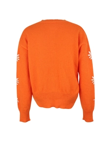 Back view of an orange knit sweater featuring white daisy embroidery on long sleeves