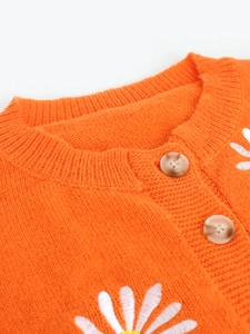 Bright orange knit cardigan featuring delicate white daisy embroidery and round buttons