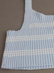 Detail of light blue and white striped knit camisole featuring vertical ribbed texture