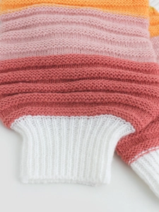 Women's striped knit cardigan in coral, orange and pink tones with ribbed cuffs