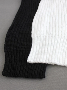 Two-piece black and white knit beach vacation set featuring chunky texture and ribbed cuffs