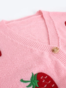 Pink knit cardigan with strawberry embroidery and marble button V-neck detail