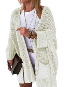 Detail of cream chunky knit cardigan featuring textured mesh pattern and front pockets