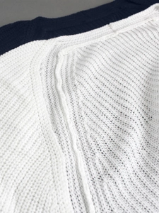 Close-up of ribbed knit texture and stitching details on a two-piece beach vacation set