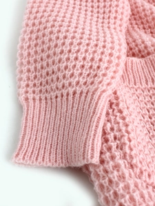 Pink open knit waffle cardigan featuring hollow texture and ribbed sleeve cuffs