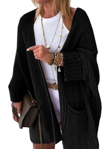 Close-up of black chunky knit cardigan featuring drop shoulders and side pockets