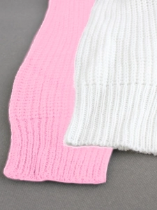 Detailed macro view of pink and white chunky knit fabric with ribbed cuff textures