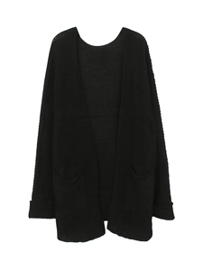 Detailed close-up of a black knitted cardigan with long sleeves and front patch pockets
