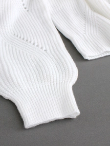 Women's white knitted long sleeve dress with intricate hollow-out texture and ribbed cuffs