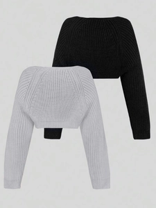 Detailed view of black and grey shrugs with ribbed knit texture and long sleeves