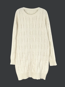 Beige long-sleeve cable-knit crewneck dress with ribbed cuffs on dark background