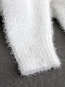 White fuzzy knit sweater with off-shoulder cut and ribbed cuffs in plush mohair style