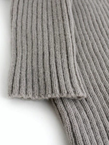 Grey cropped rib-knit sweater featuring textured long sleeves and elastic cuffs