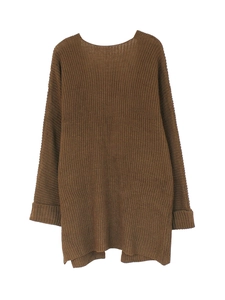 Macro detail of dark brown chunky knit sweater with ribbed cuffs and side slit design