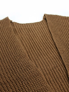 Detail of dark brown ribbed knit texture on a cozy long-sleeve cardigan sweater