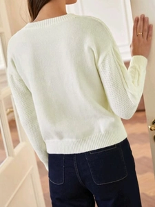 Women's crewneck light green knit sweater with textured honeycomb sleeves and ribbed edges