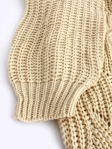 Beige hollow knit crewneck sweater featuring thick honeycomb weave and ribbed cuffs