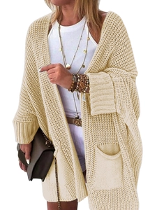 Detail of beige chunky knit long cardigan featuring drop shoulders and large front pockets