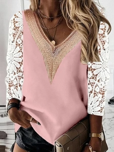 Detail of V-neck pink top with intricate lace sleeves and floral embroidery textures