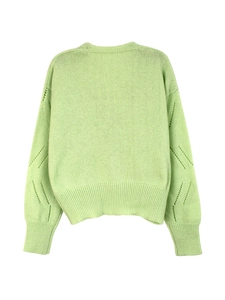 Detail view of light green knit cardigan featuring cable knit textures and ribbed cuffs