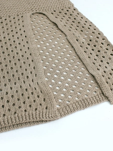 Close-up of khaki crochet knit fabric with hollow diamond mesh pattern and ribbed hem