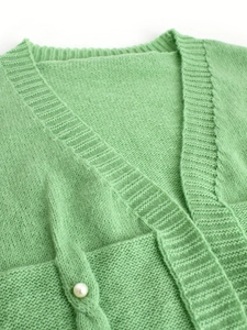 Women's light green knit cardigan with V-neck design and delicate pearl button detail