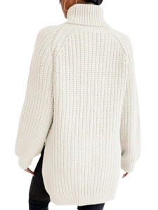 Detail eines grob gestrickten Rollkragenpullovers mit Seitenschlitzen in Off-White