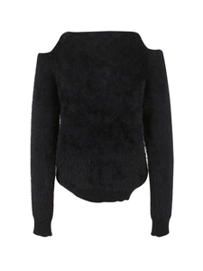 Detail of black cold-shoulder knit sweater featuring soft long faux fur texture and ribbed cuffs
