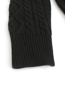 Close-up of black cable-knit dress cuff with detailed ribbed texture and soft fabric